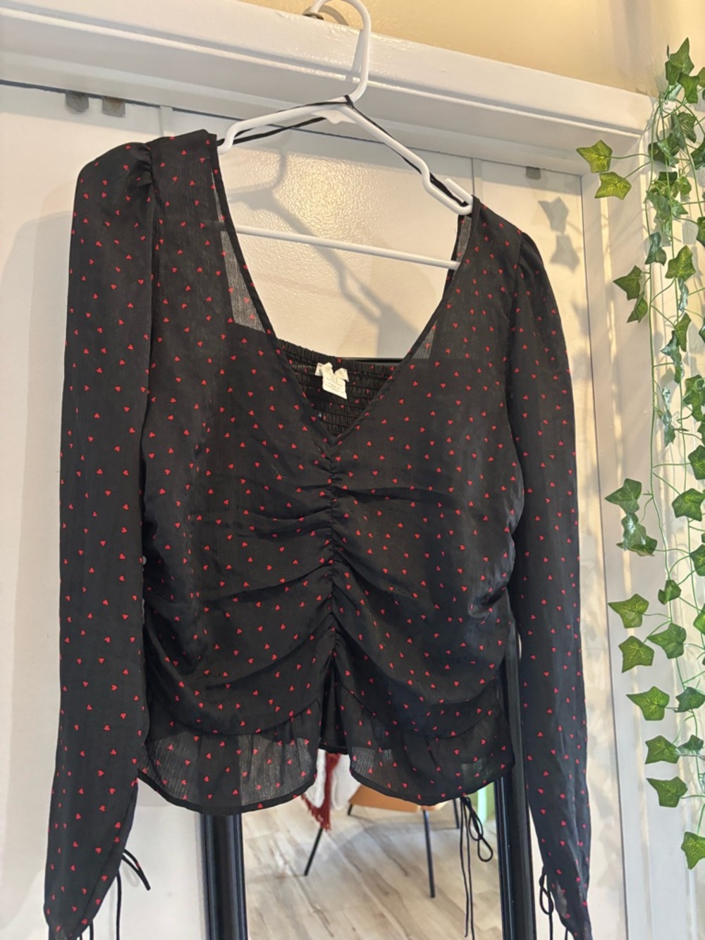 Black Long-Sleeve Ruched V-Neck Top with Red Heart Print